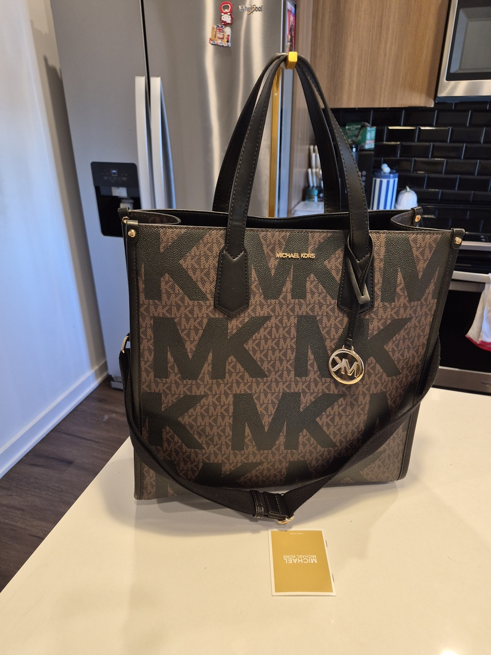 Michael Kors Maple Large North/South Logo Tote Bag in a brown and black monogram
